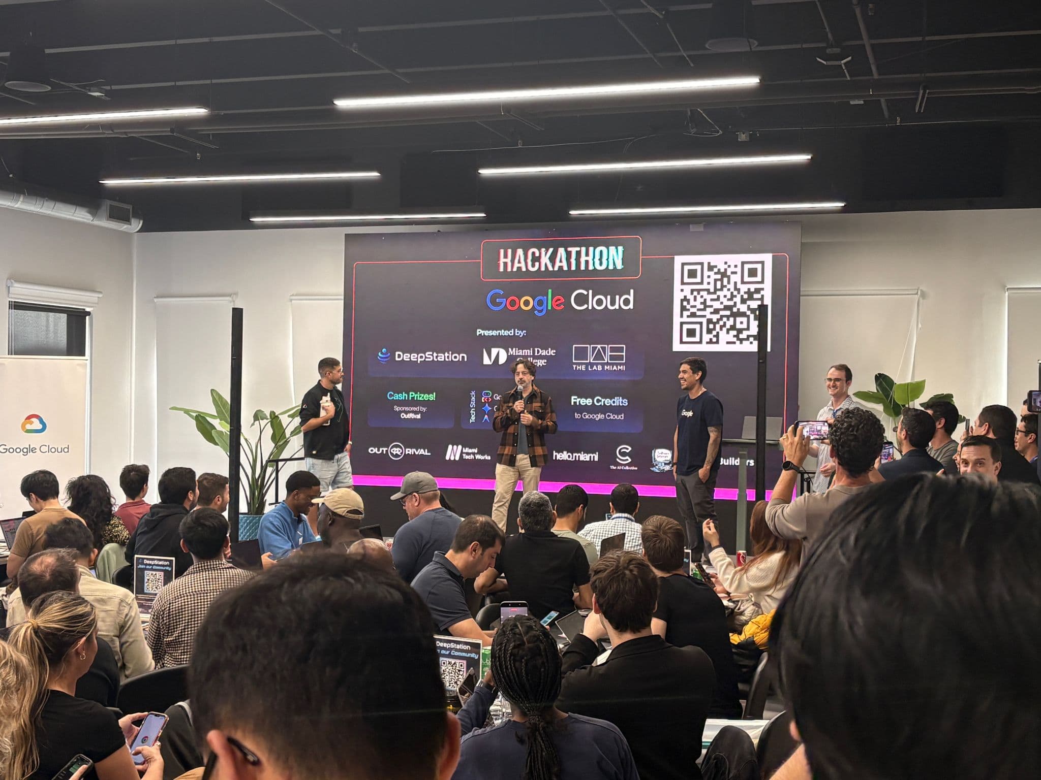 Sergey Brin on stage at DeepStation Hackathon with packed crowd