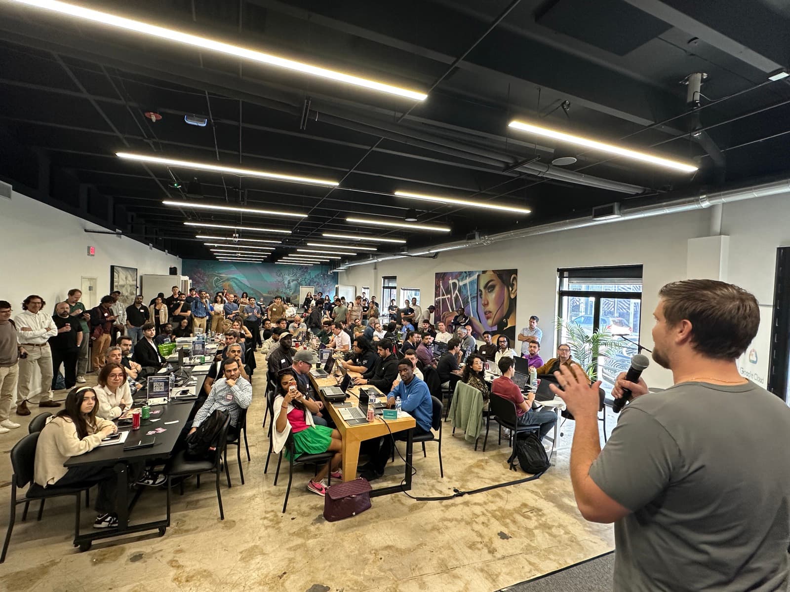 Speaker addressing the packed hackathon crowd