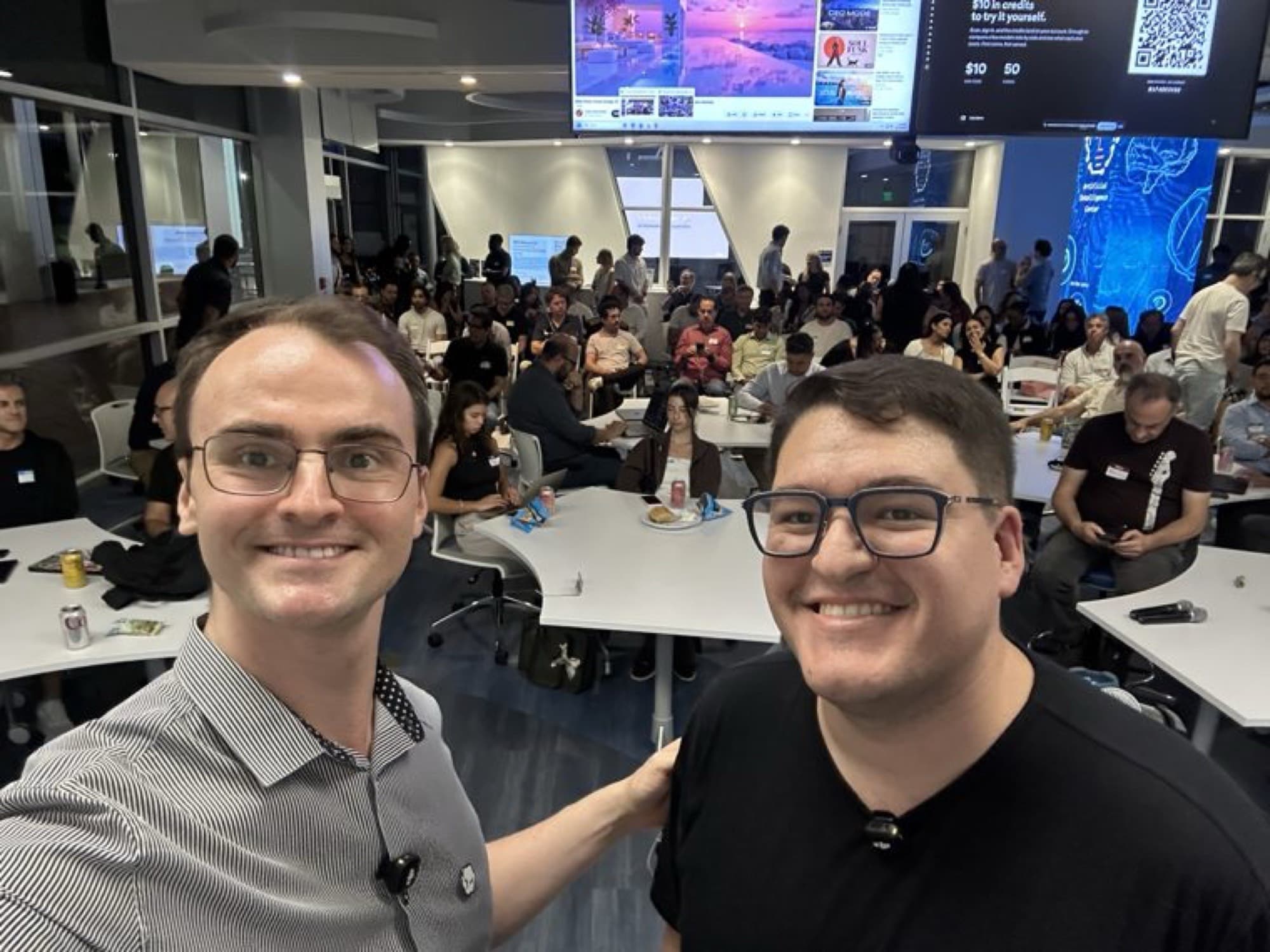 Two members in front of a full room at the AI Demo Night